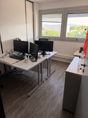 an image of an office with two computer monitors on a desk