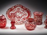 a lot of red and white glass items on a table