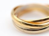 a close up of a gold ring on a white surface