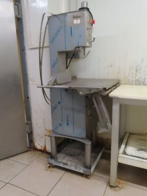 une image d'une cuisine avec un réfrigérateur et une table