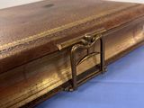 a wooden box with a handle on a blue surface
