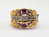 a close up of a gold ring with diamonds and a purple stone