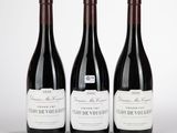 trois bouteilles de vin rouge posées sur une table blanche