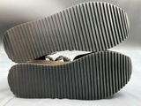 a pair of shoes that are sitting on a white surface
