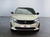 the front of a white car in a room with a black floor