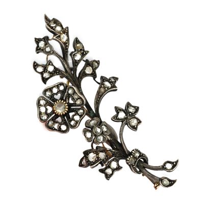 un gros plan d'une broche en forme de fleur ornée de perles