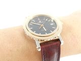 wrist shot of a watch on a woman ' s wrist with a white background