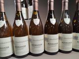 several bottles of wine are lined up on a table
