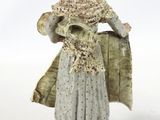 a figurine of a woman with a hat and scarf