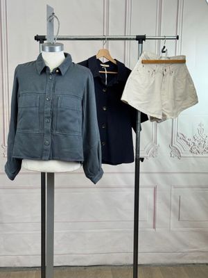 a mannequin with two shirts on it and a pair of shorts on a stand