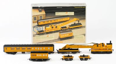 a toy train set with a yellow train car and other toy trains