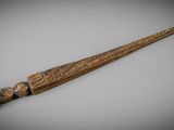 a close up of a wooden stick on a white surface