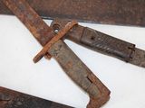 two old rusty knives on a white surface
