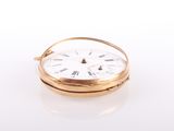a close up of a gold pocket watch with roman numerals
