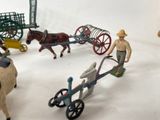 toy figurines of a farmer and a horse pulling a cart