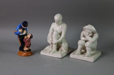 three figurines of a man and a woman sitting on a bench