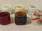 many different types of candles on a white surface