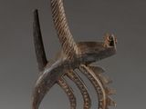 an image of a sculpture of a bird and a fish on a stand