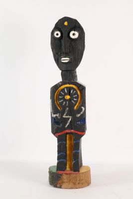 a wooden statue of a man with a clock in his hand