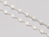 a close up of a chain of diamonds on a gray surface