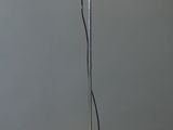 three lights that are on a pole in a room