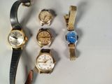 a lot of watches that are sitting on a table