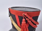 an old hat with a red tassel on top of it