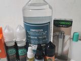 a bottle of liquid, a bottle of e - liquid, a bottle of e - liquid, a box of e - liquids, and a box of