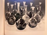 a lot of vases that are sitting on a table