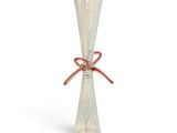 a glass vase with a red ribbon tied to it