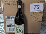 a bottle of wine sitting on a table next to a cardboard box