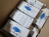 several boxes of gloves are packed in a cardboard box