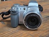 a silver camera sitting on a wooden table