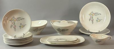 a lot of plates and bowls that are sitting on a table