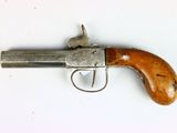 an old gun with a wooden handle on a white surface