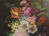 a painting of flowers in a vase on a table in a gold frame