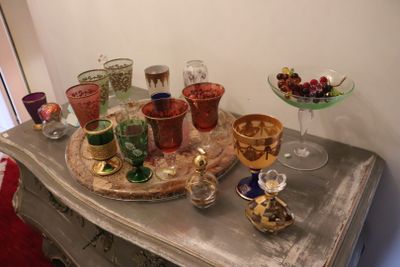 a table with a tray of wine glasses and a tray of fruit on it