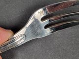 a person holding a fork in their left hand