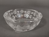 a clear glass bowl with flowers in it on a table