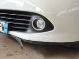 a close up of a white car with a license plate on it
