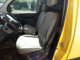 a small yellow van with two seats and a steering wheel