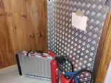 two fire extinguisors and a tool case in the corner of a room