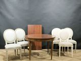 four chairs and a table on a wooden floor