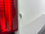 a close up of the tail light of a white truck