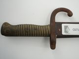 a knife that is on the wall with a tag on it