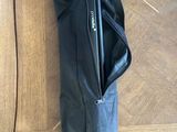 a black umbrella that is sitting on a wooden floor