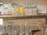 many glasses on the shelves in the kitchen