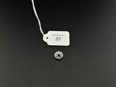 a close up of a white tag on a black surface