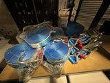 many blue plastic bowls and other items on a table