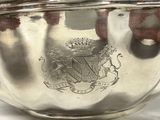 a silver bowl that has a coat of arms on it